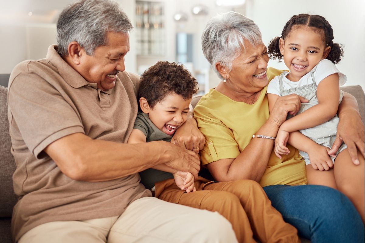 Grandparents enjoying time at home with their two grandchildren